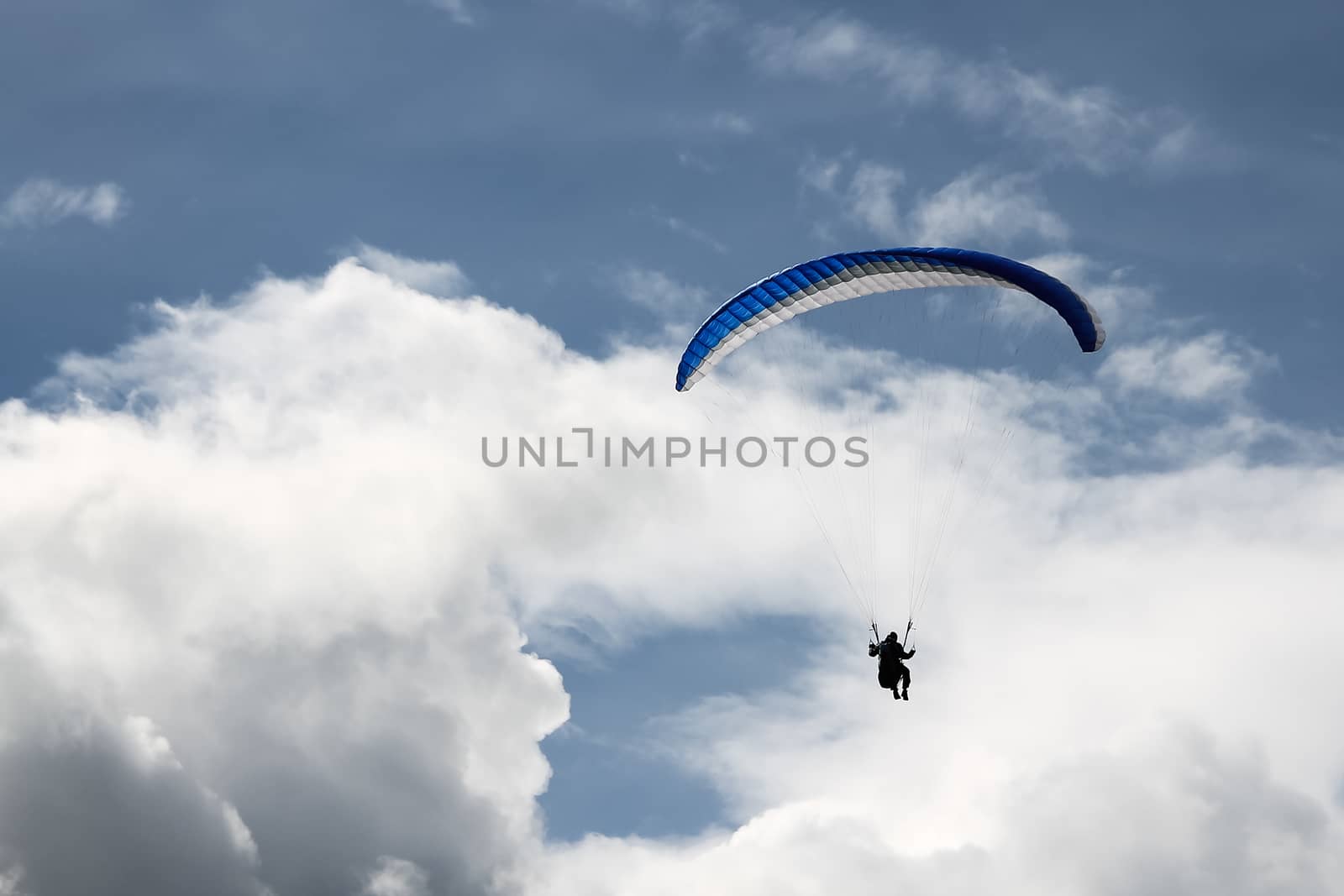 Paragliding in the blue cloudy skies by Alexanderphoto