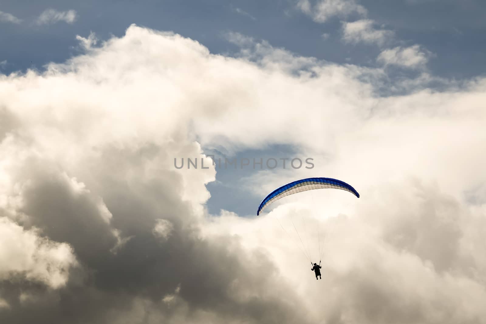 Paragliding against the dramatic cloudy sky