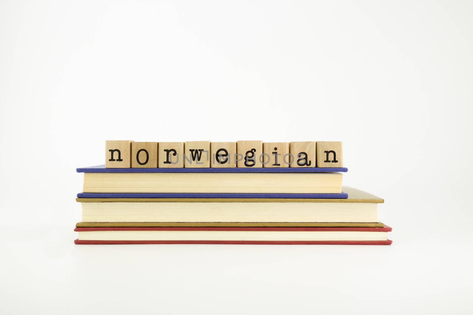 norwegain word on wood stamps stack on books, language and conversation concept