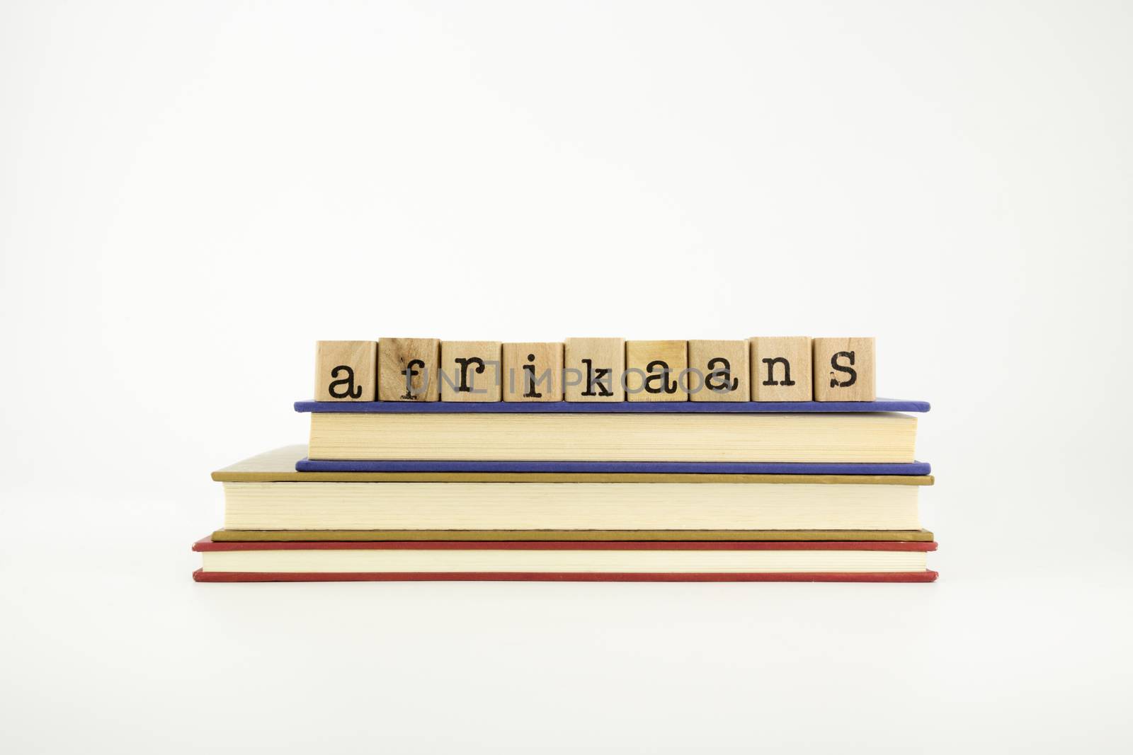 afrikaans word on wood stamps stack on books, language and conversation concept