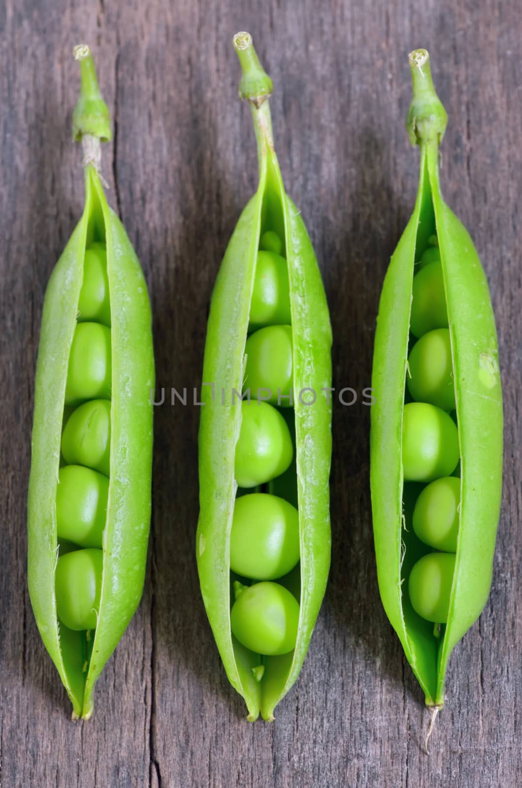 Fresh green peas on wooden table