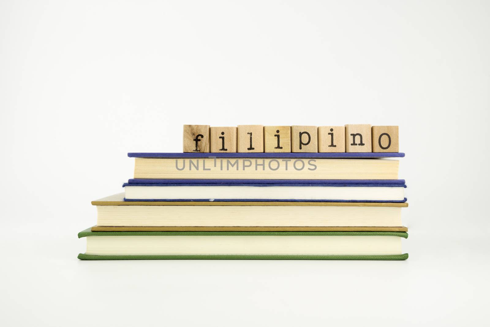 filipino word on wood stamps stack on books, language and conversation concept