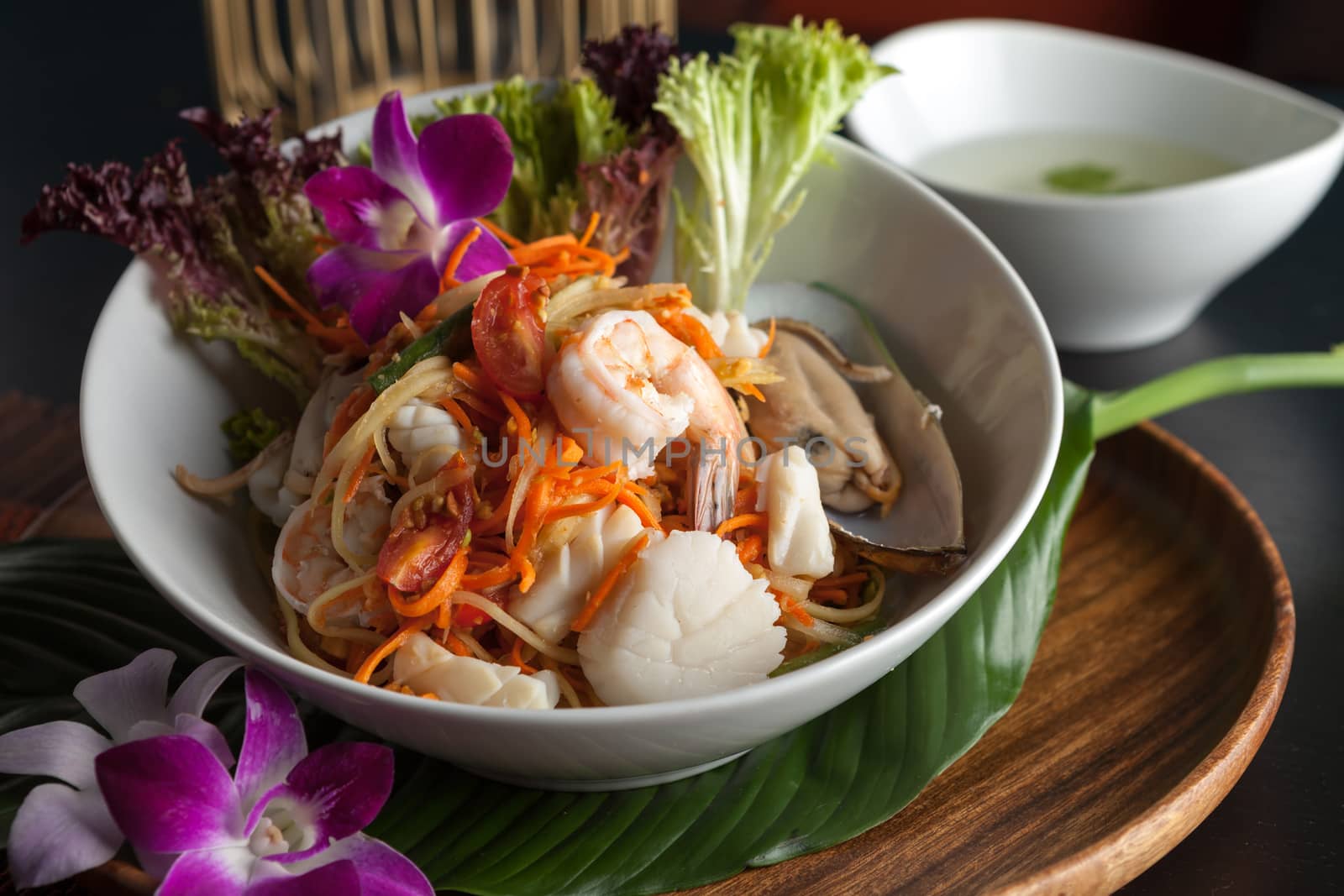 Traditional dish of freshly prepared Thai food.  Thai seafood and som tum green papaya salad.