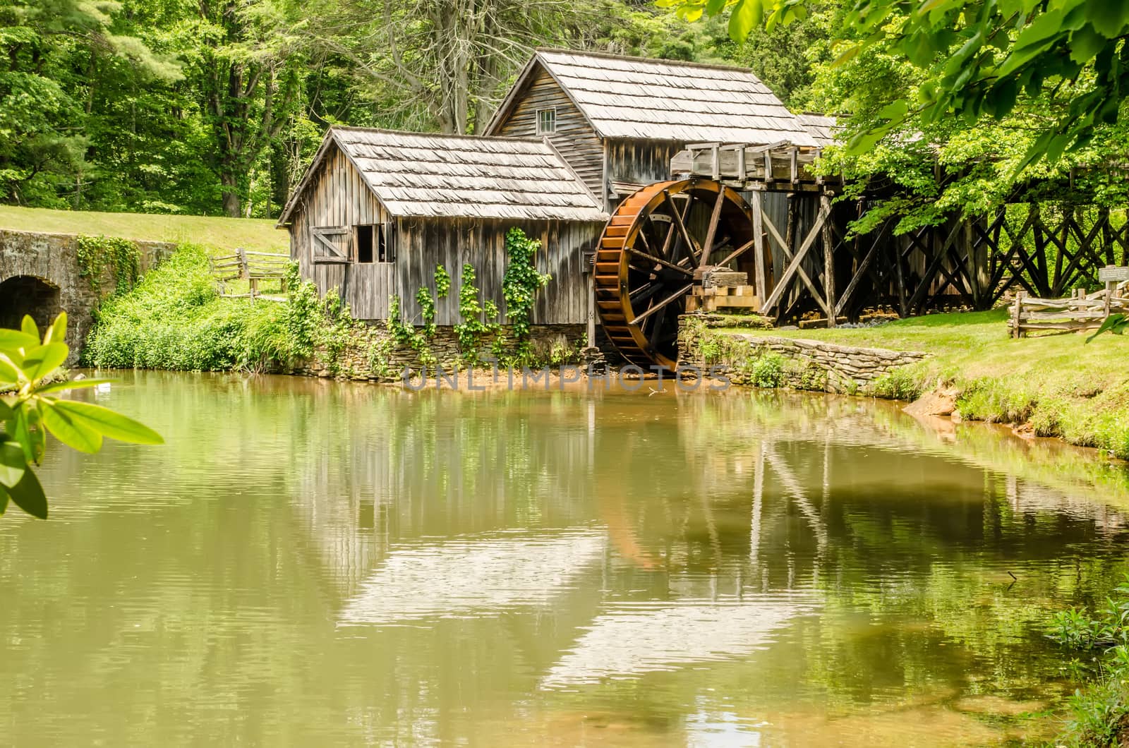 Historic Edwin B. Mabry Grist Mill (Mabry Mill) in rural Virginia on Blue Ridge Parkway and reflection on pond in summer