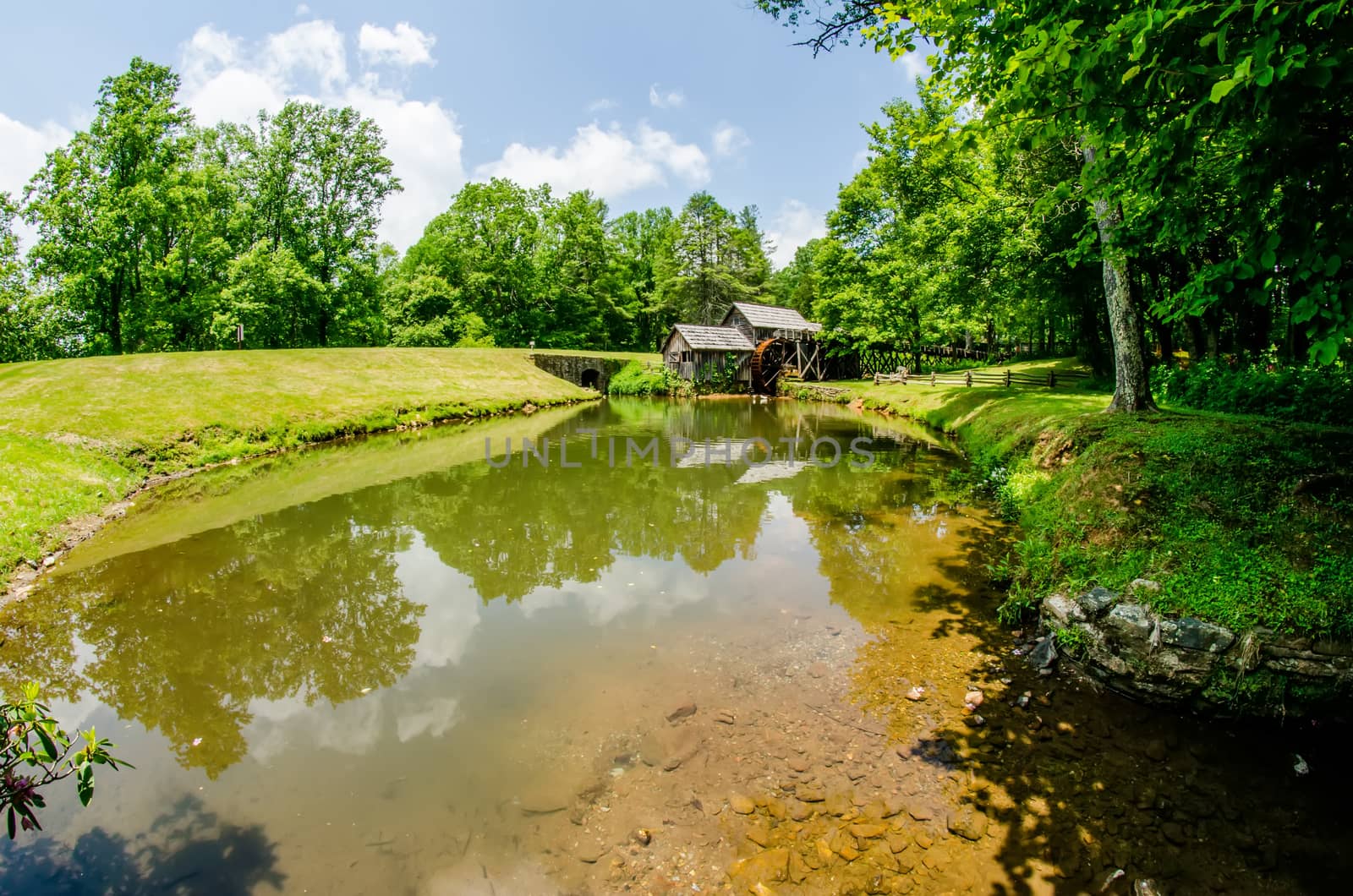 Historic Edwin B. Mabry Grist Mill (Mabry Mill) in rural Virginia on Blue Ridge Parkway and reflection on pond in summer