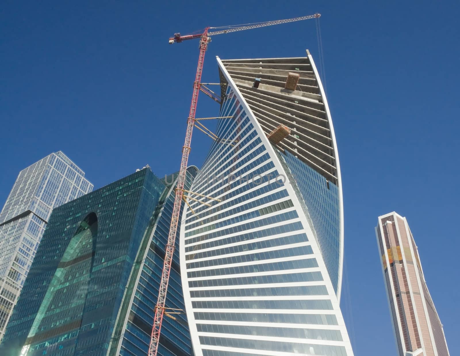 Elevating crane on construction of office buildings in the Moscow business center