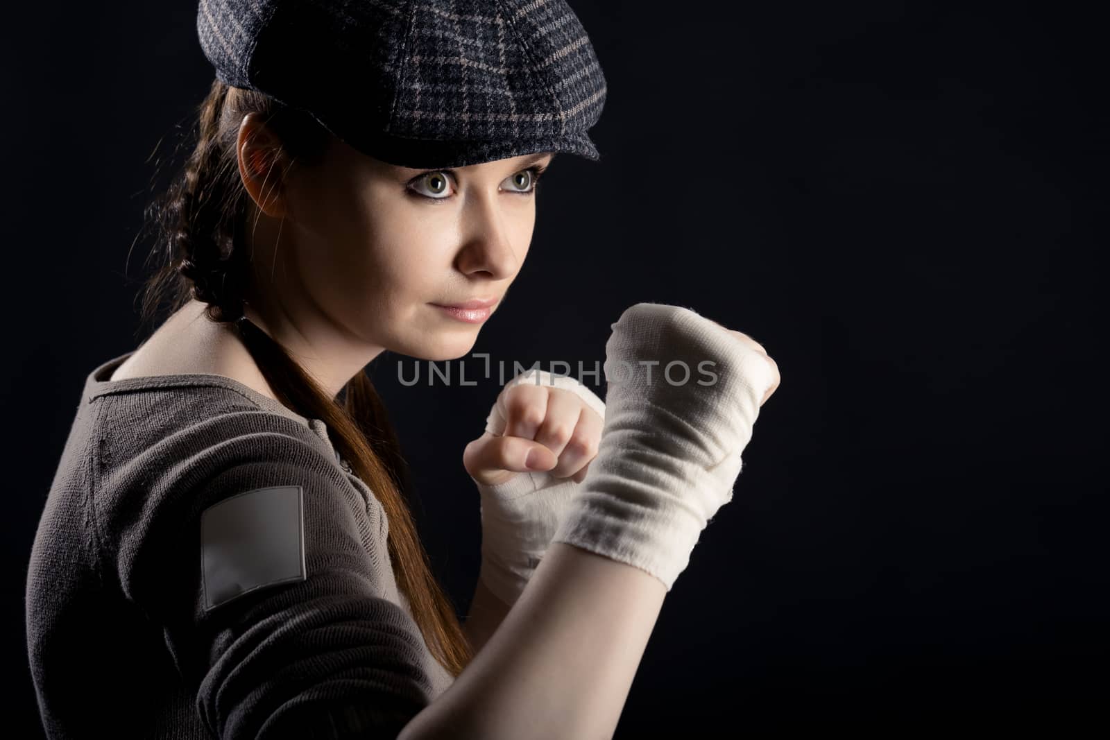 On a black background girl with a fighting stance