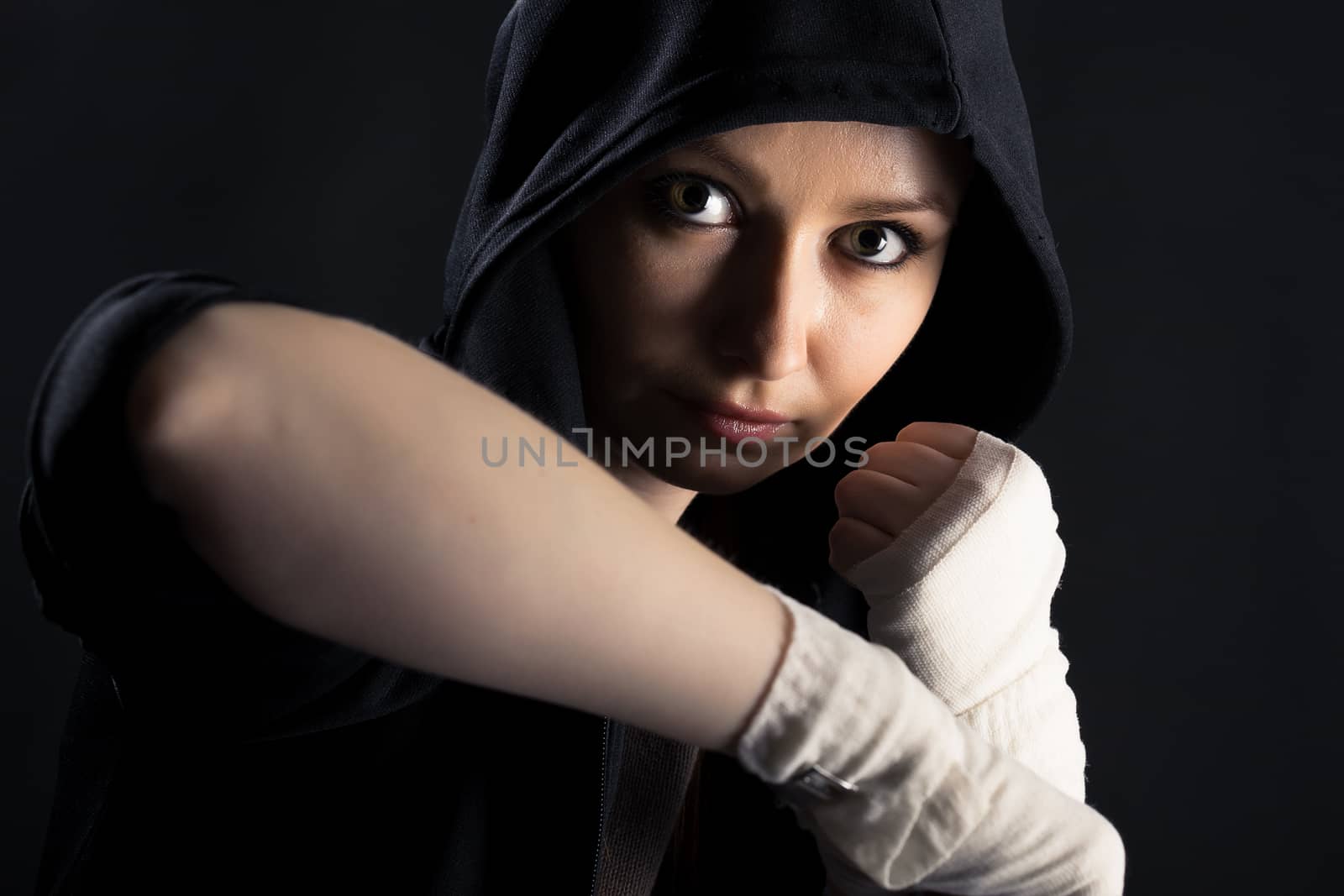 On a black background girl with a fighting stance