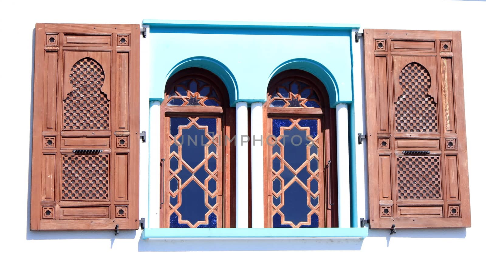 Oriental style window with two wooden shutters by sunny day