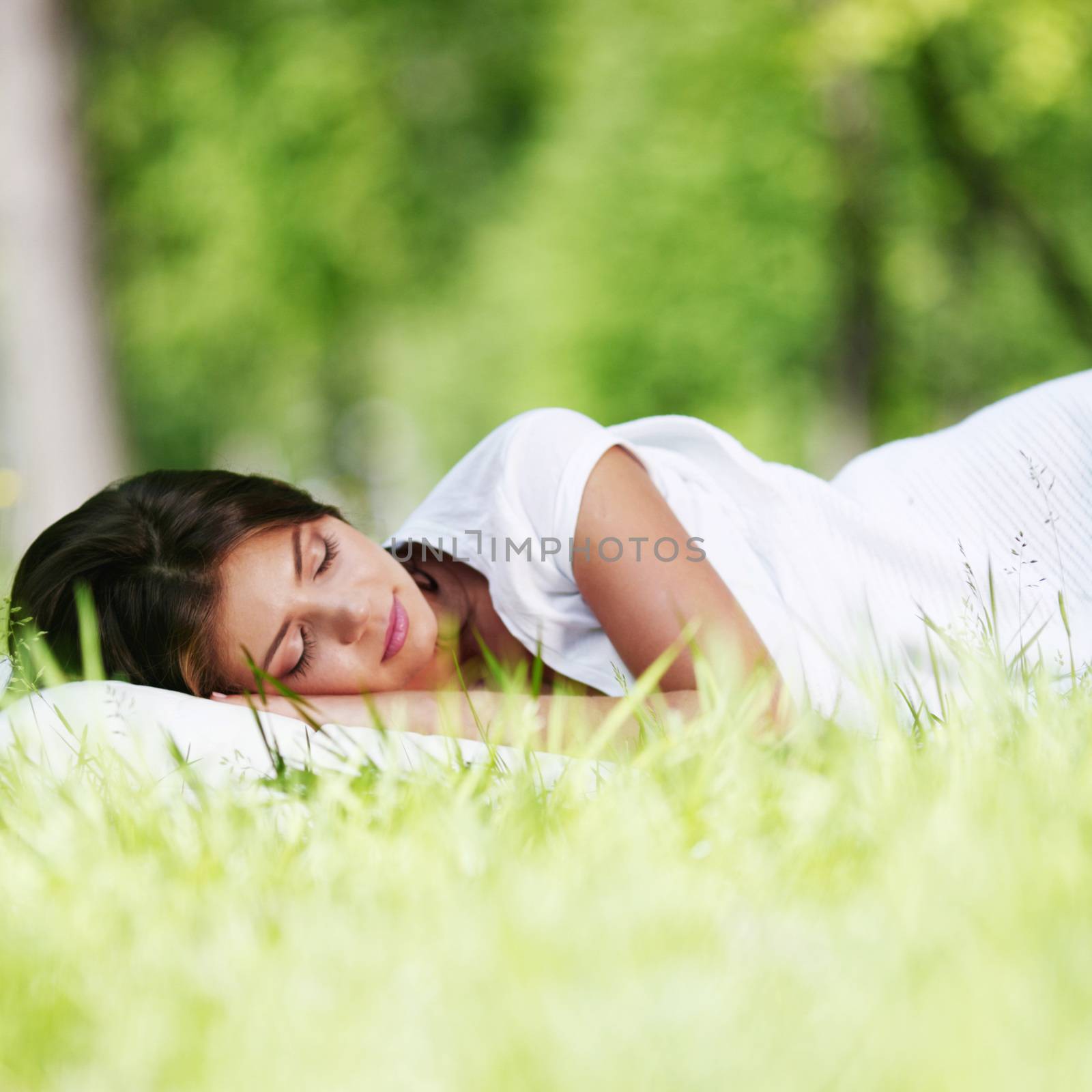 Woman sleeping on grass by Yellowj