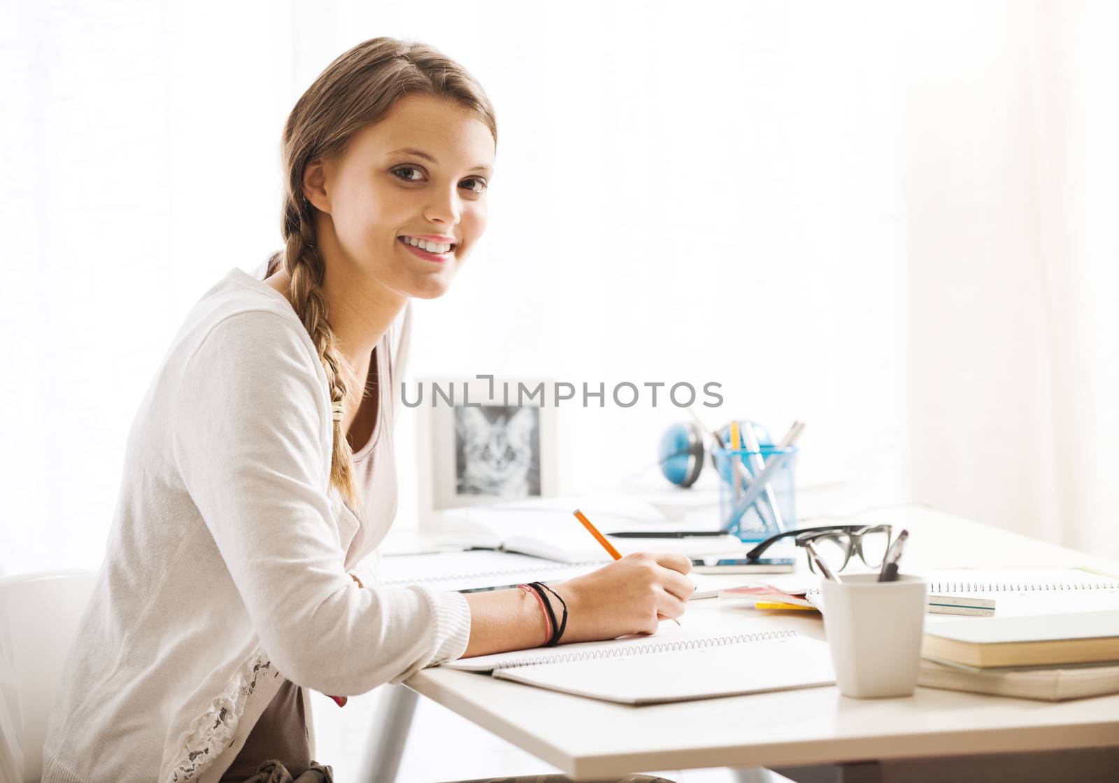 Portrait of a beautiful girl studying at home