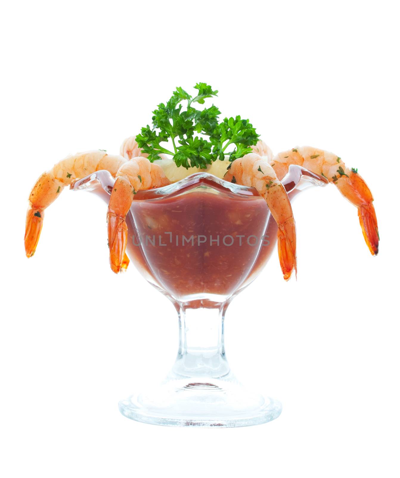 Shrimp cocktail served with seafood cocktail sauce and a wedge of lemon.  Shot on white background.
