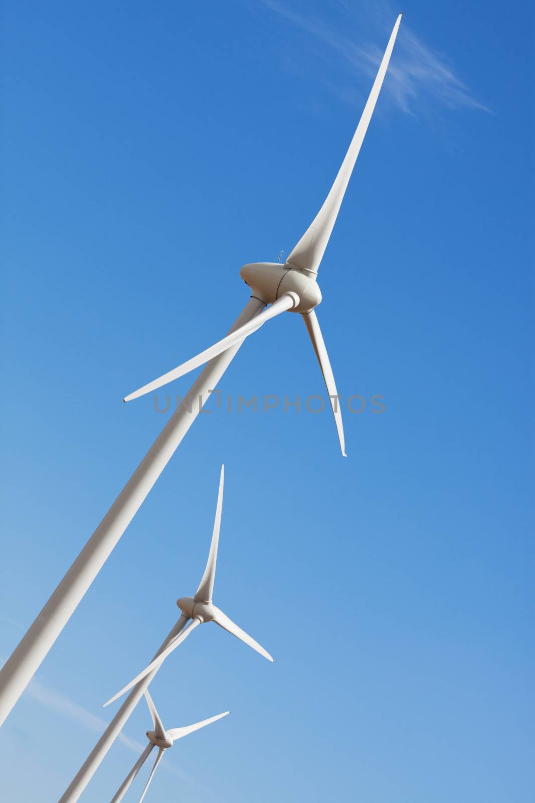 Wind turbines against prairie sky, create green energy.