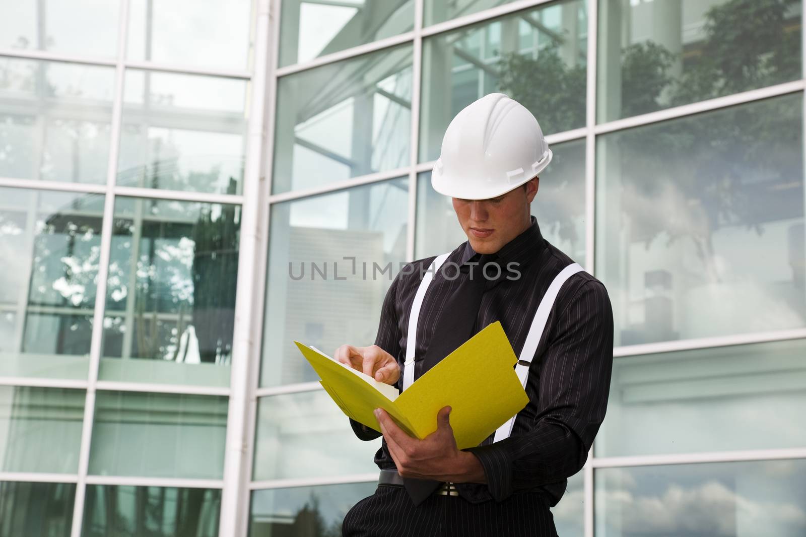 A foreman checks his blueprints outside of city hall.
