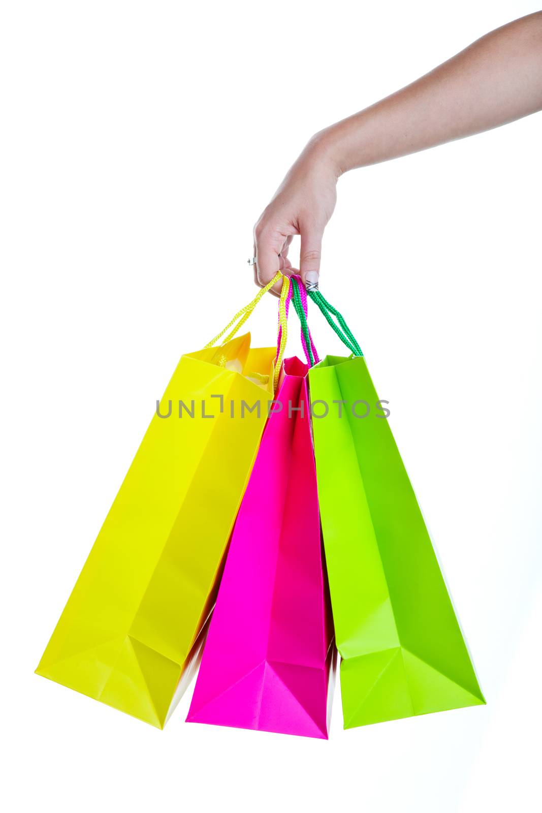 Shopper holding shopping bags, in bright spring colors.  Shot on white background.