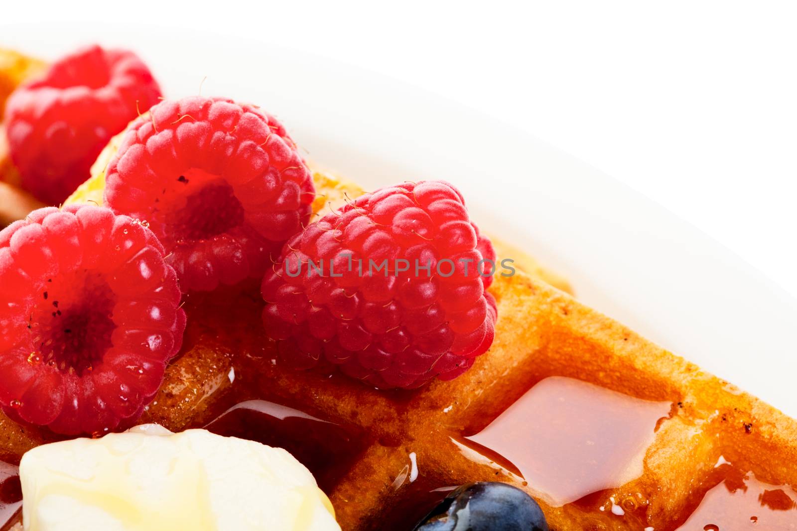 Waffles with mixed berries and syrup macro.