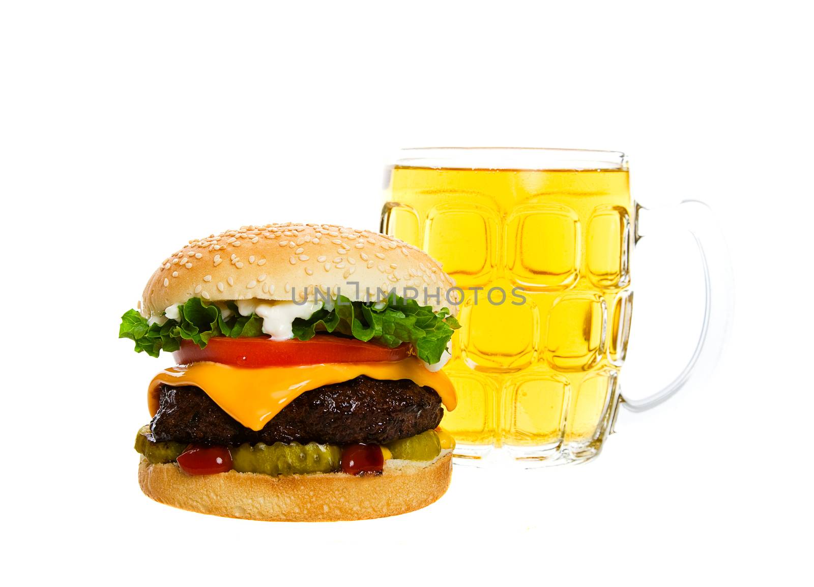 Juicy Angus beef burger topped with cheese, tomatoes & lettuce on a golden sesame seed bun along with a thirst quenching mug of beer.  Shot on white background.