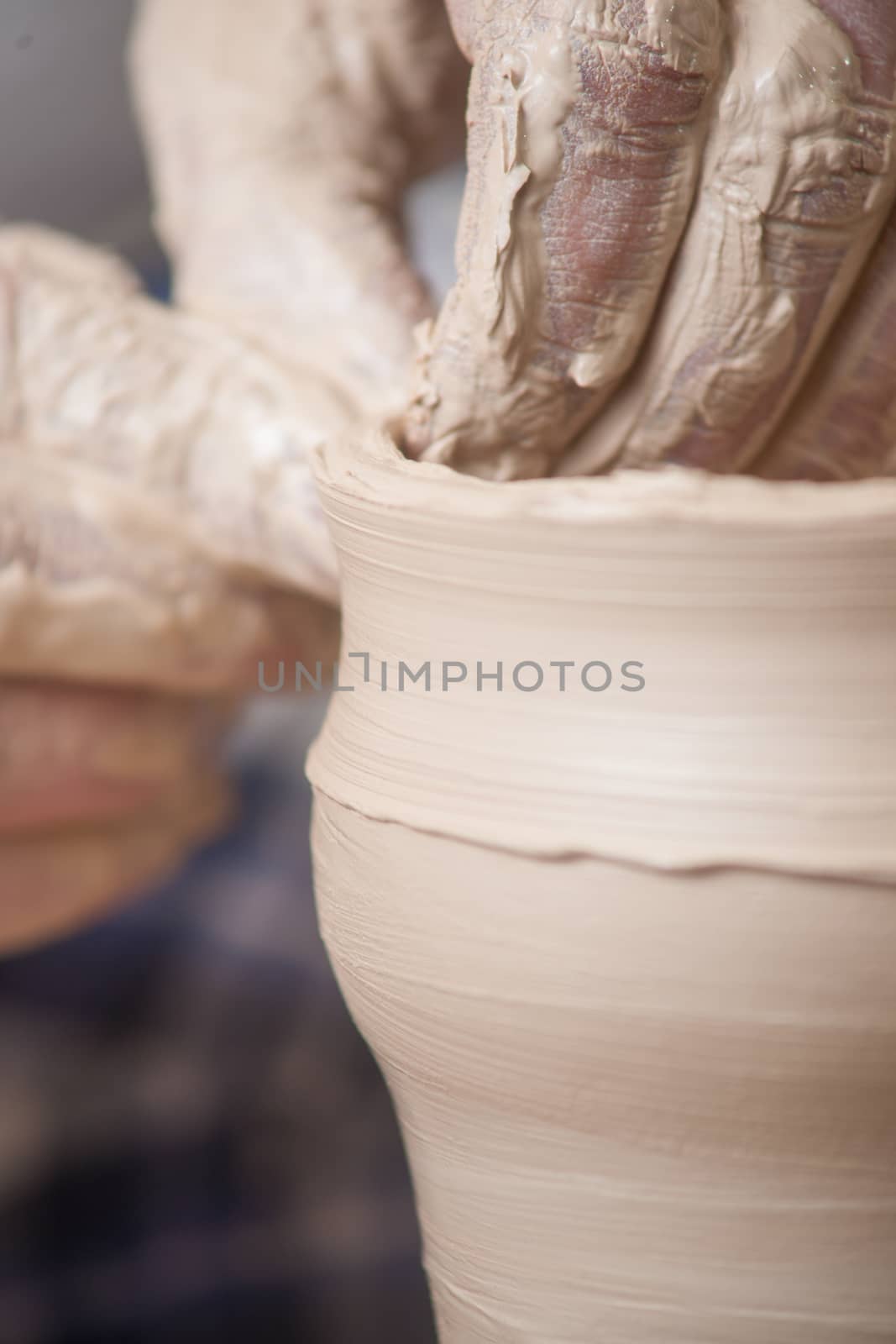 Hands of a potter, creating an earthen jar on the circle