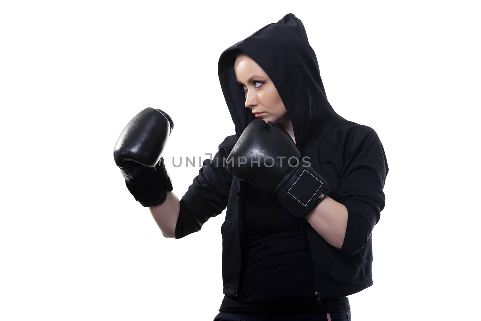 Young serious woman in boxing gloves on a white background