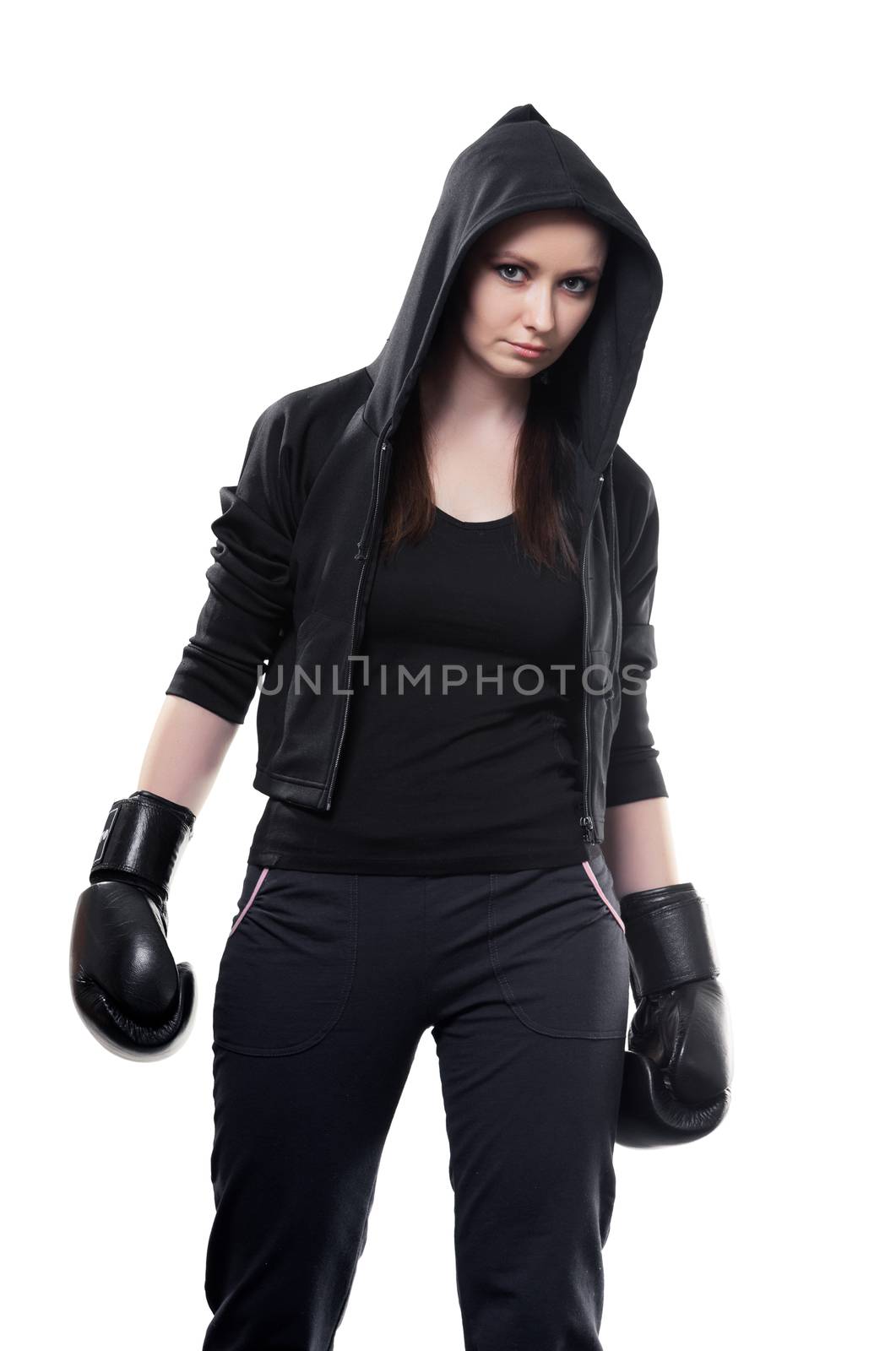 Young serious woman in boxing gloves on a white background