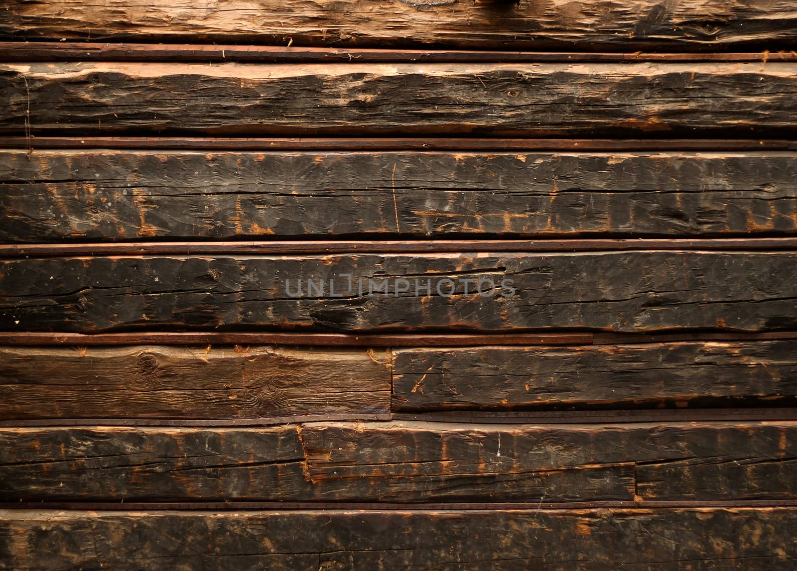 Old smutty log wall of rustic wooden cabin 
