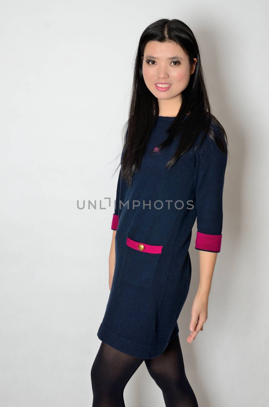 Asian woman wearing casual clothes, navy blue dress. Chinese female model, friendly face expression.