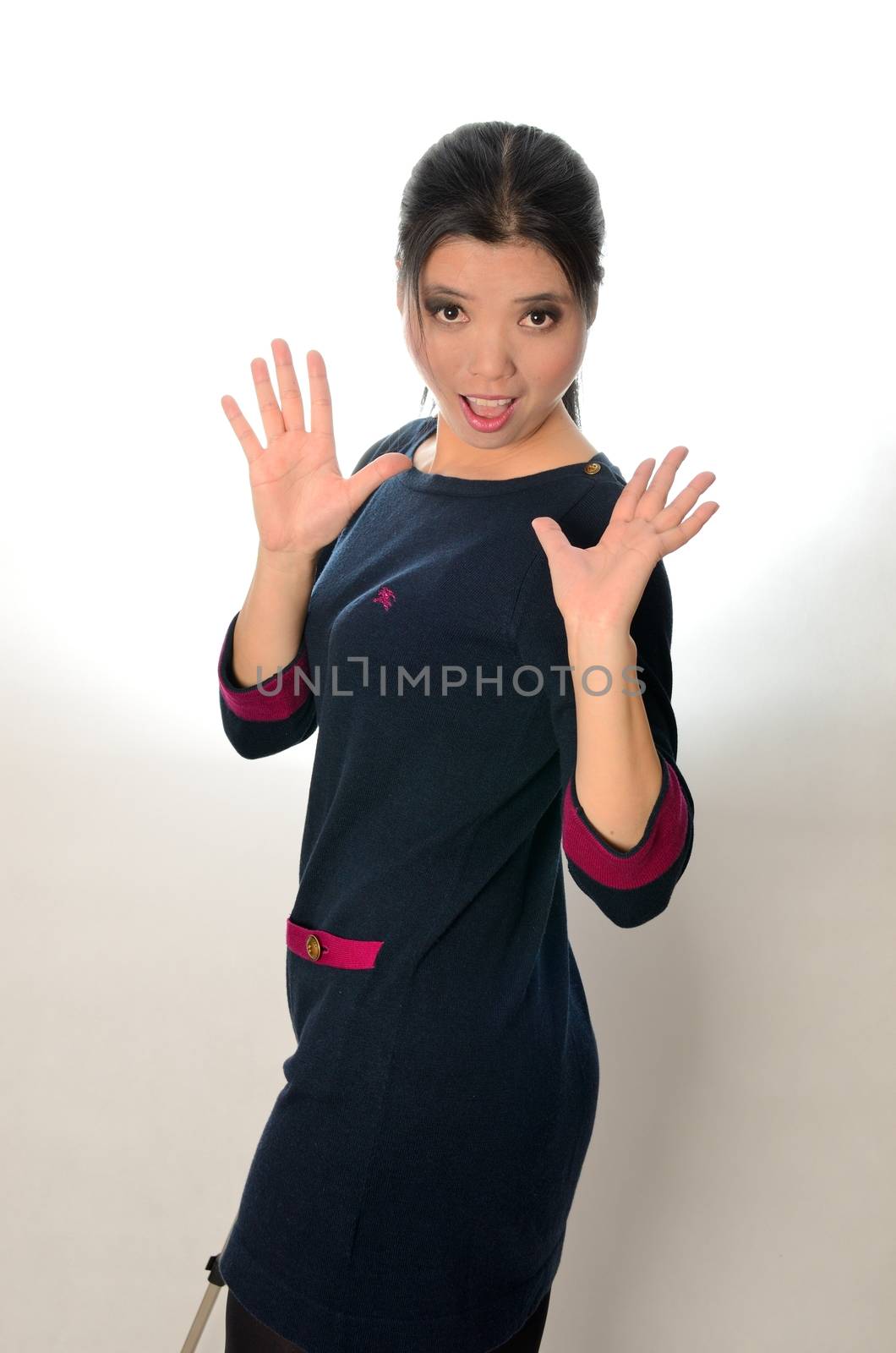 Asian woman wearing casual clothes, navy blue dress. Chinese female model, surprised face expression.