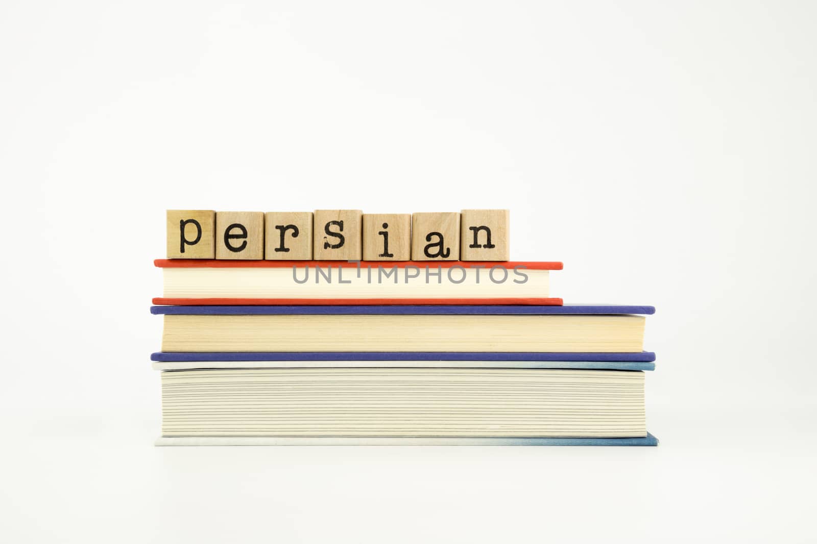 persian word on wood stamps stack on books, foreign language and translation concept