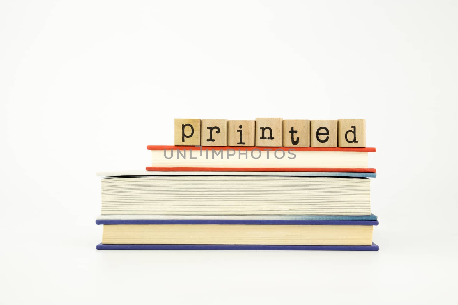 printed word on wood stamps stack on books, knowledge and academic concept