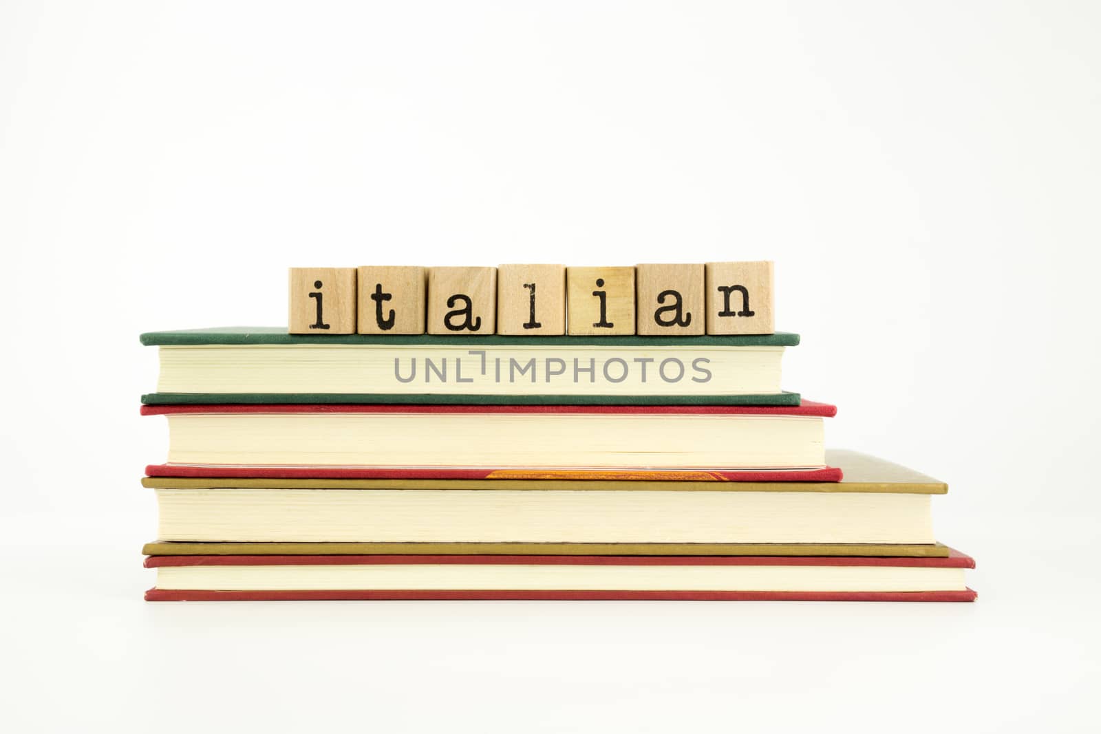 italian word on wood stamps stack on books, foreign language and translation concept