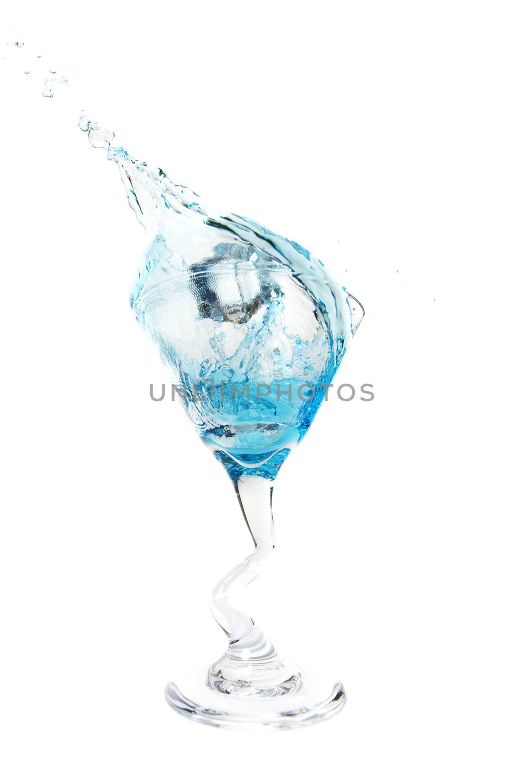 An ice cube falling into a Cosmopolitan cocktail.  Shot on white background.