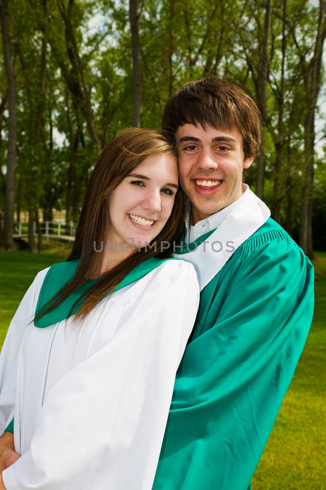 A young couple celebrating their graduation together.