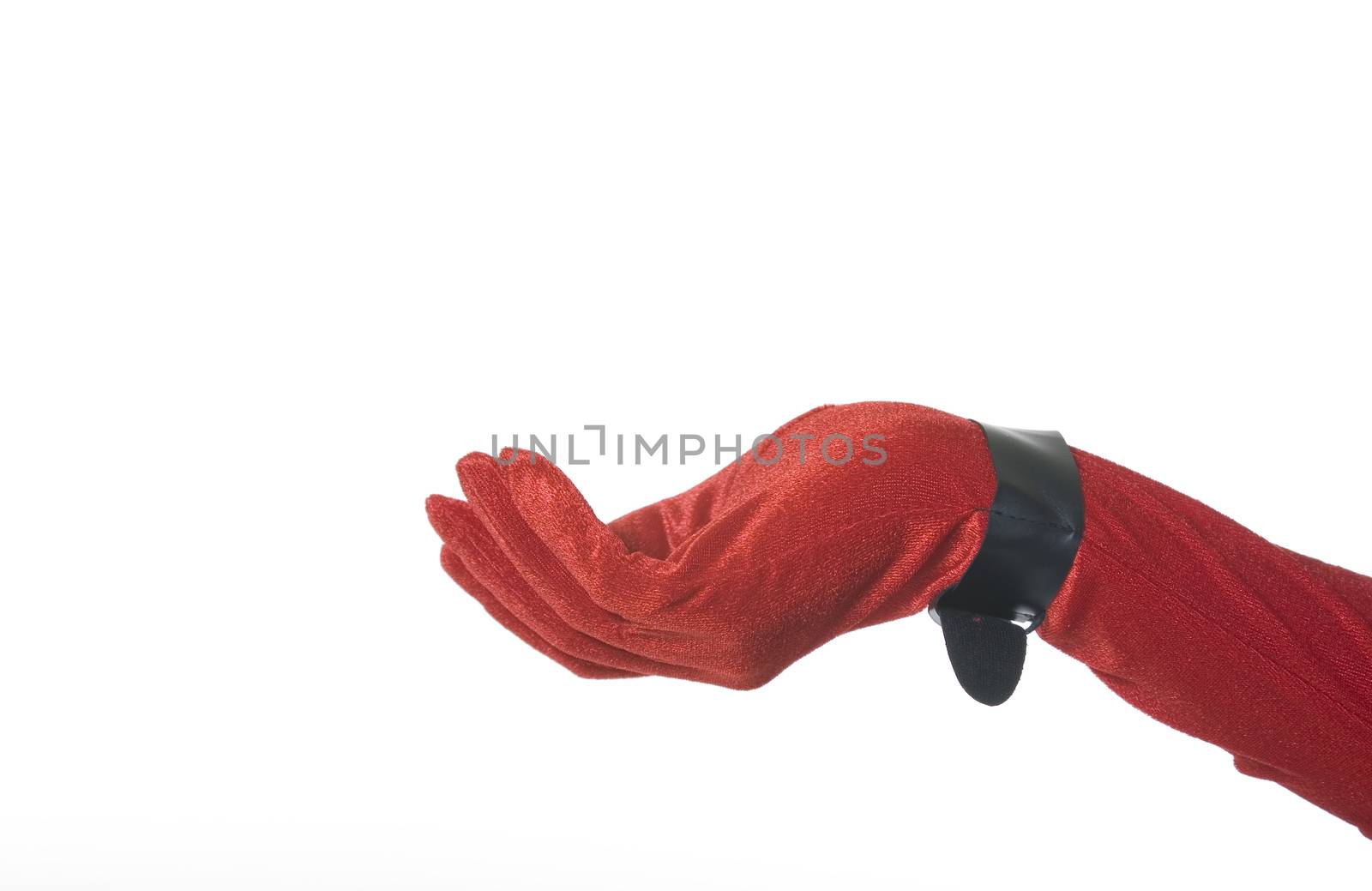 Red velvet glove with black buckle at wrist.  Graceful, feminine, hand ready to hold your product.  Christmas theme with room for copy on white background.