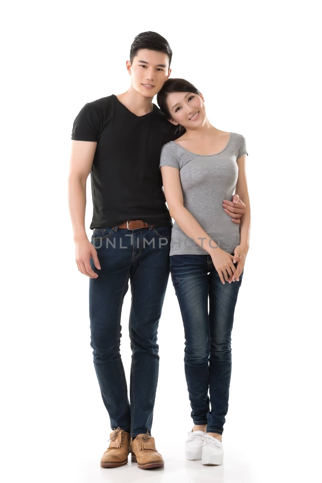 Attractive young Asian couple, full length portrait isolated on white background.