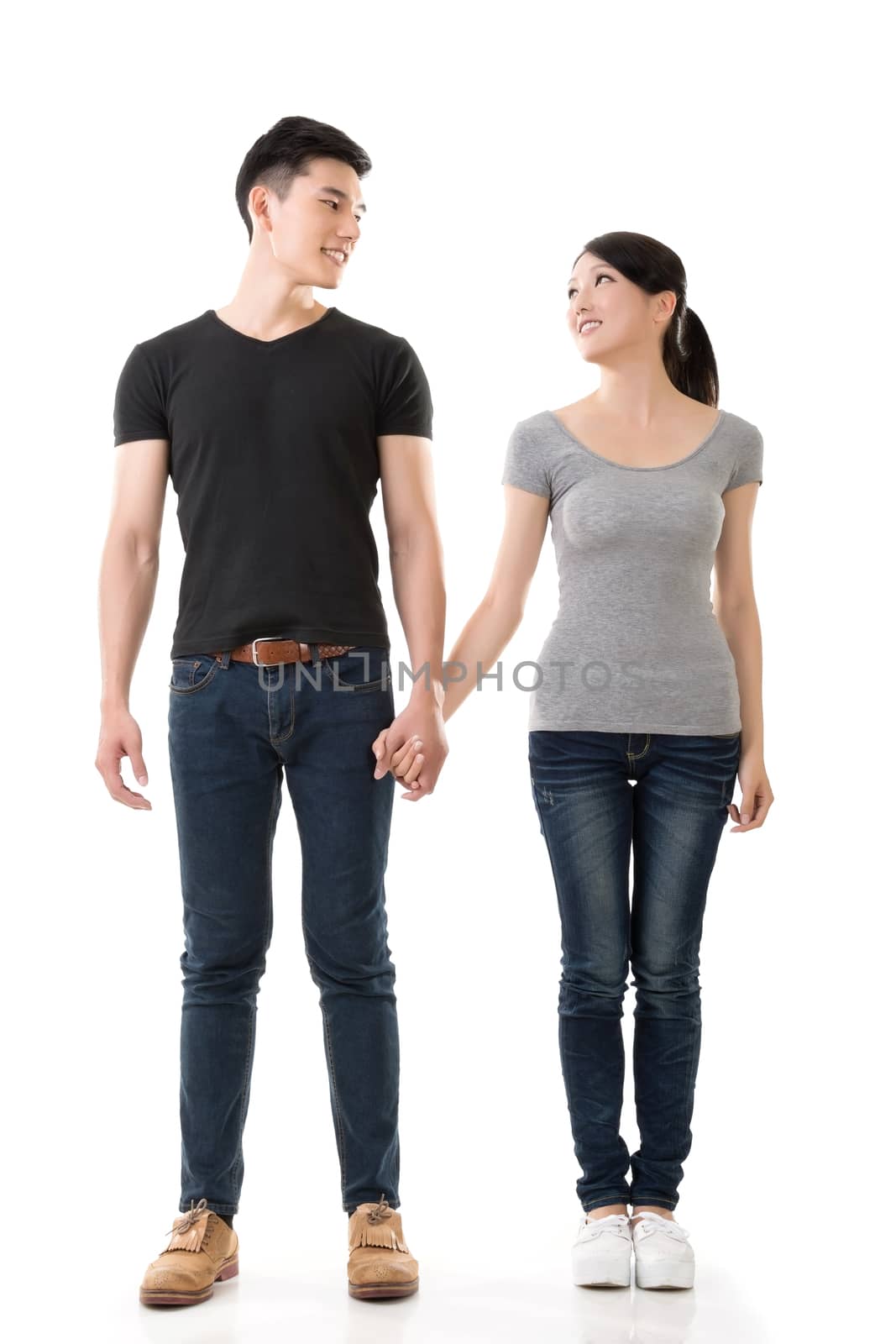 Attractive young Asian couple, full length portrait isolated on white background.