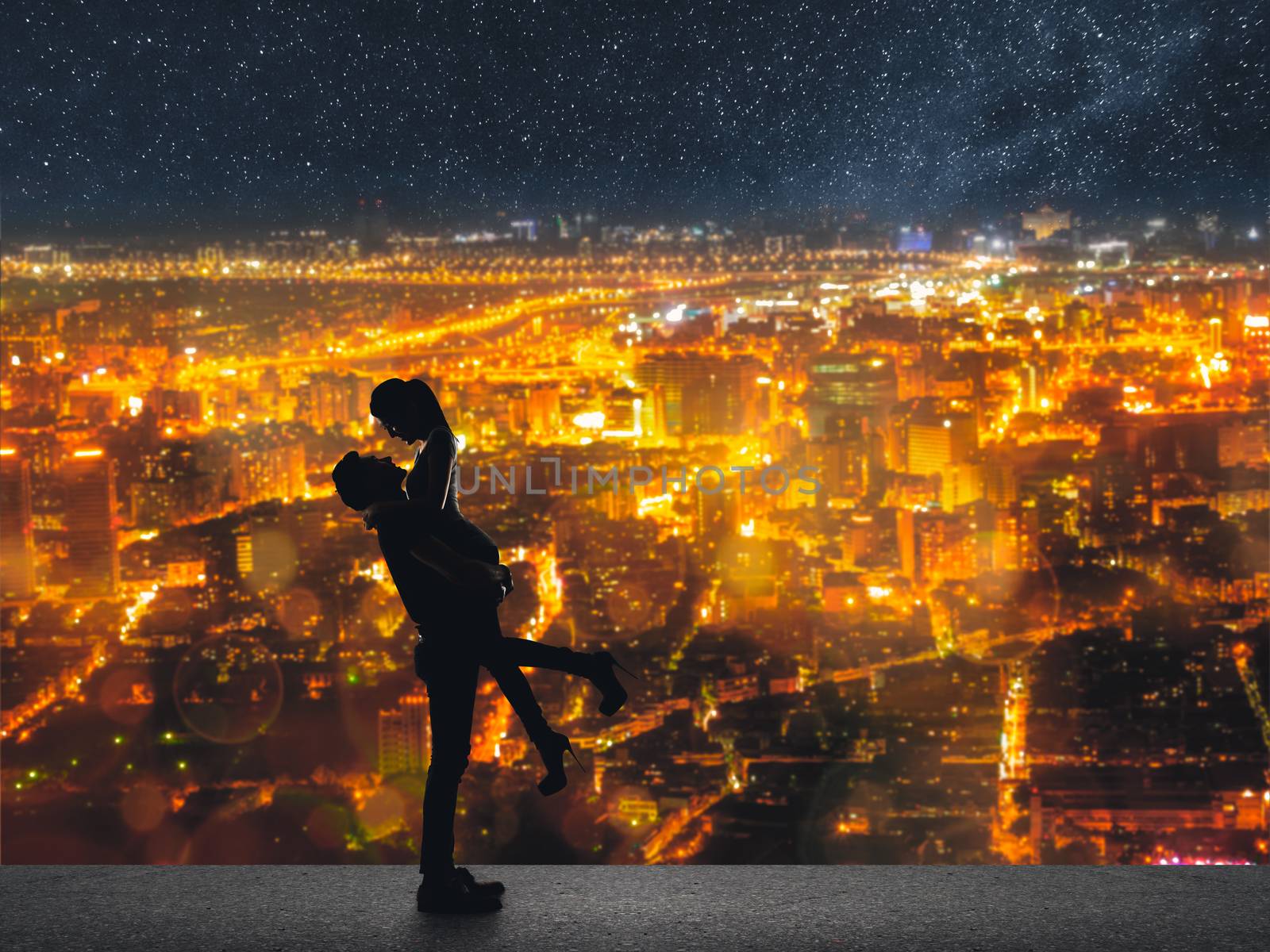 Silhouette of Asian couple, man hold his girlfriend up above the city in night under stars.