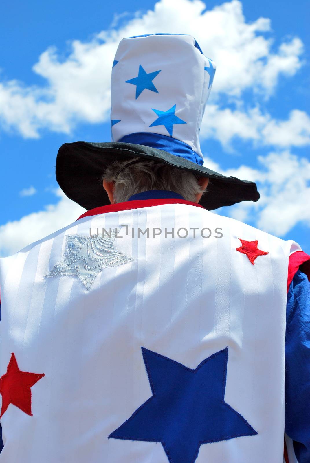 Uncle sam standing tall among the clouds.