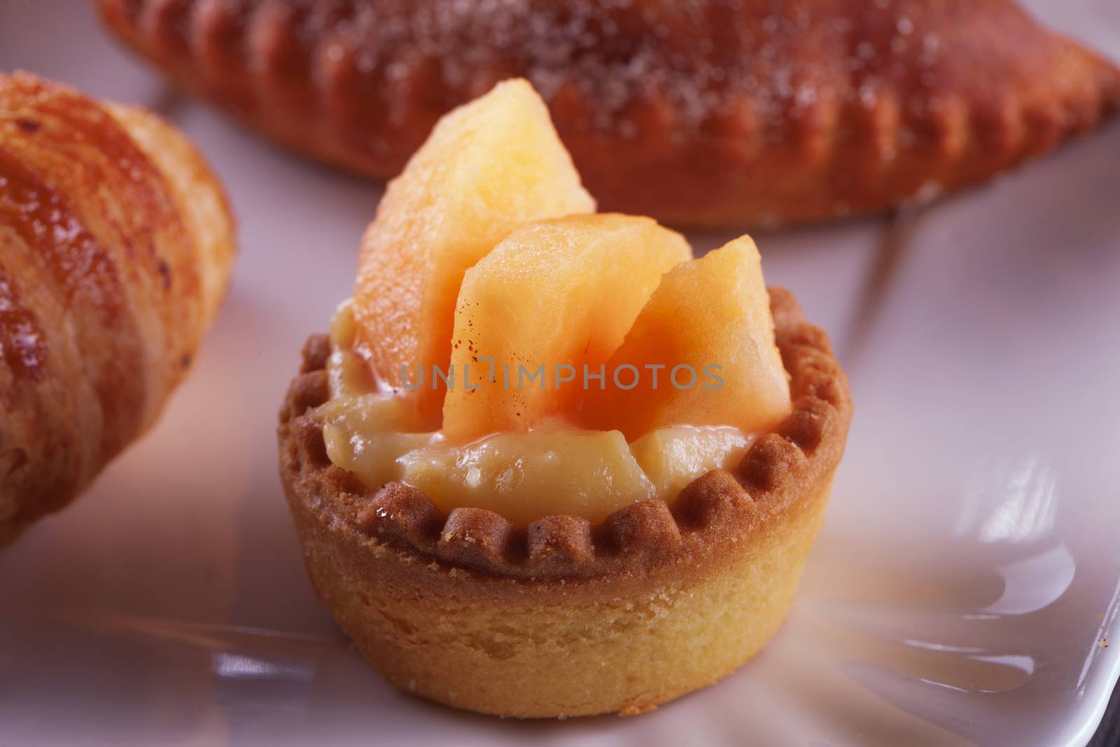 Small peach pastry over a ceramic plate