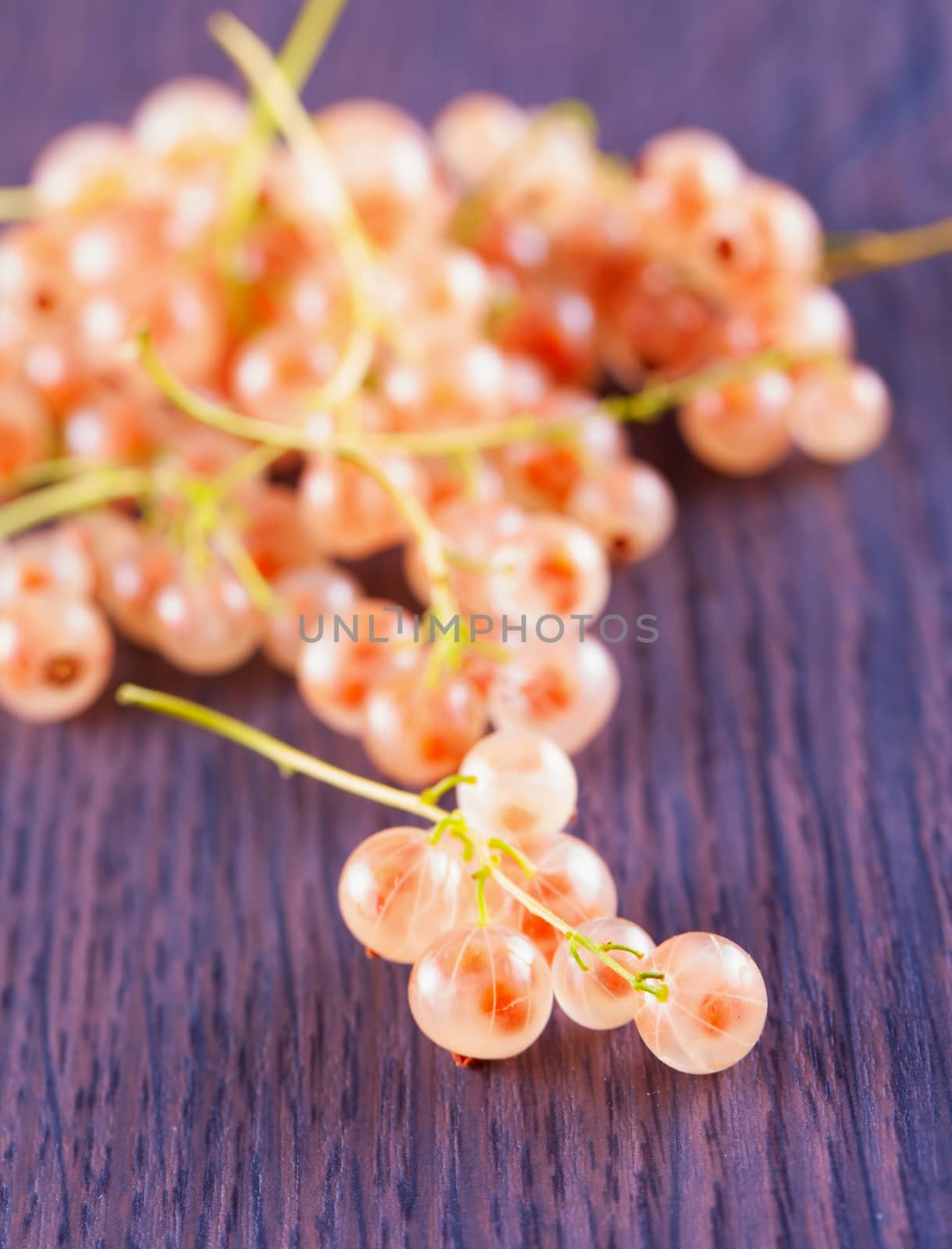 A bunch of currant over a wooden table