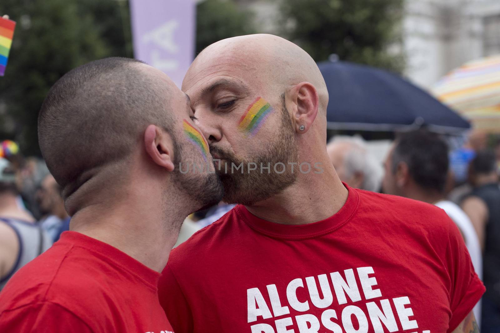 MILANO-ITALY,JUNE 28,2014:An unidentified gays kissing during in eleventh Pride Week Day. Crowd of people participate in the eleventh parade celebrates gays, lesbians
bisexuals