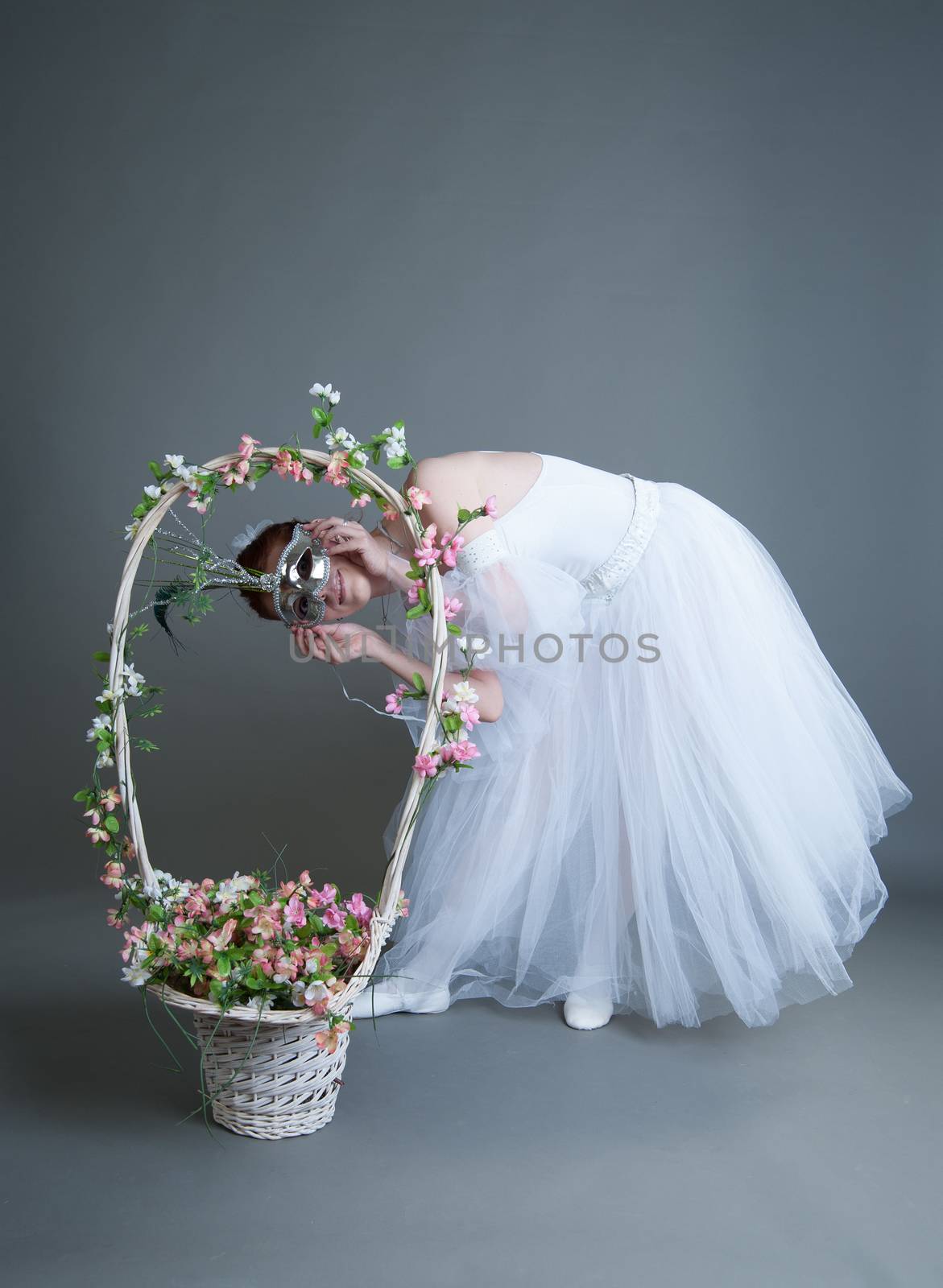 ballerina in the mask and with a basket of flowers