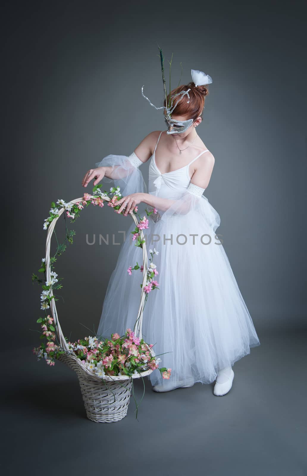 ballerina in the mask and with a basket of flowers