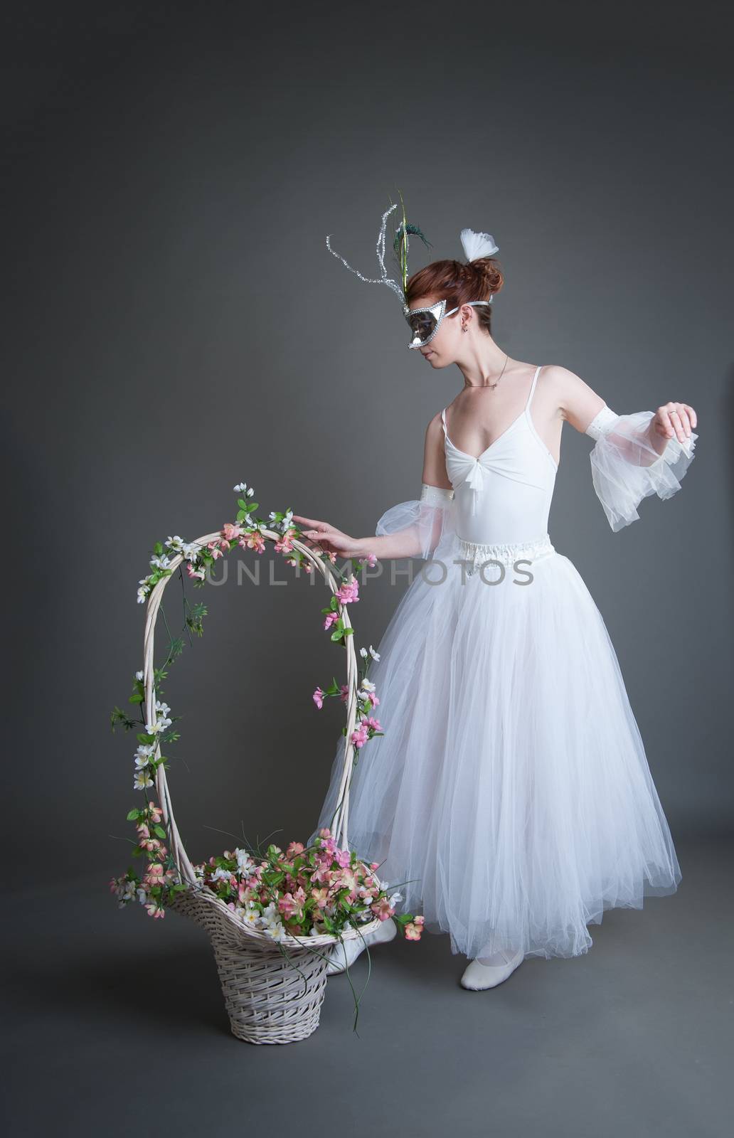 ballerina in the mask and with a basket of flowers