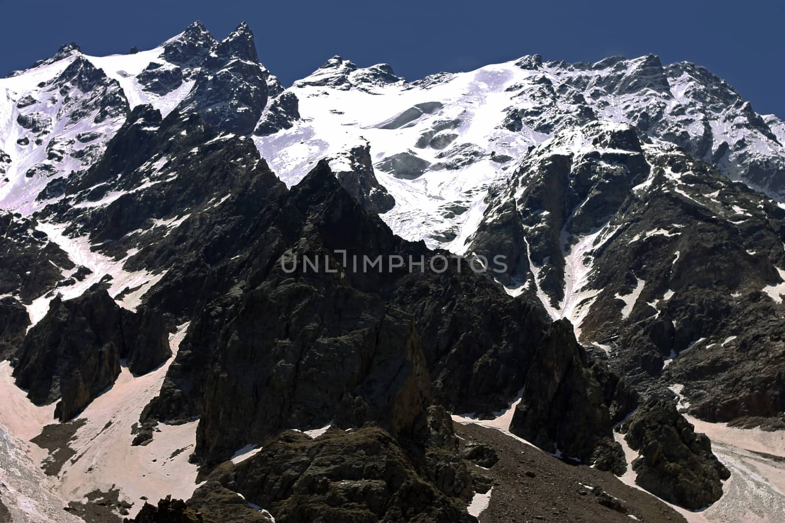 Caucasus mountains under snow and clear blue sky