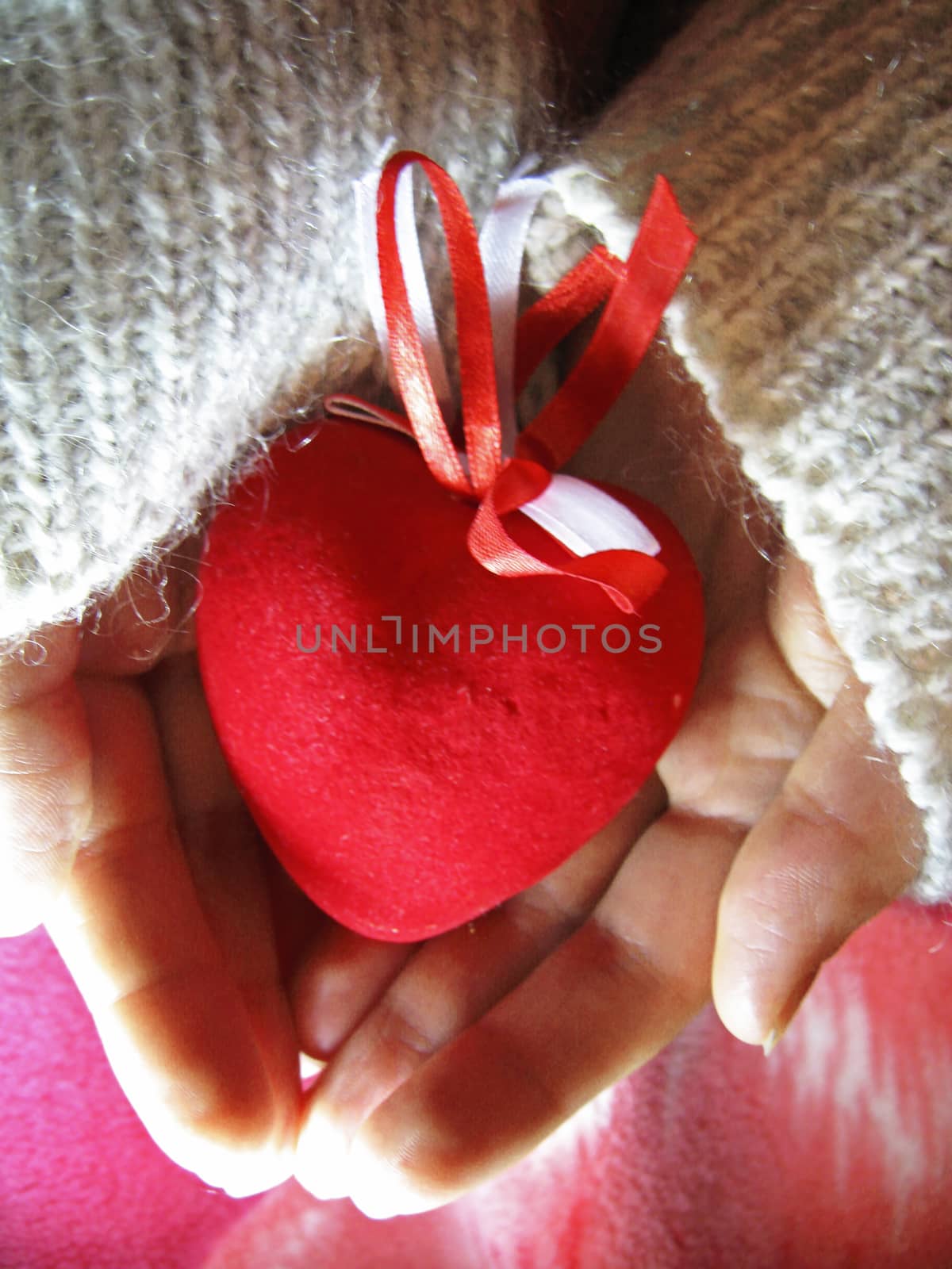 Valentine red heart in woman tender hands