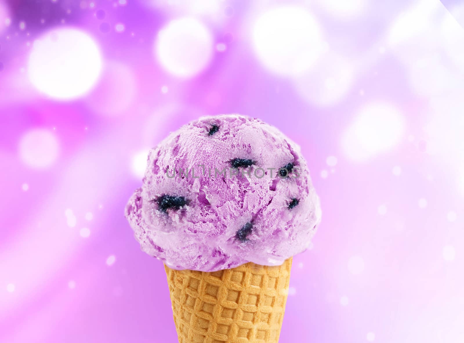 Blueberry Ice cream in the cone with abstract light background.