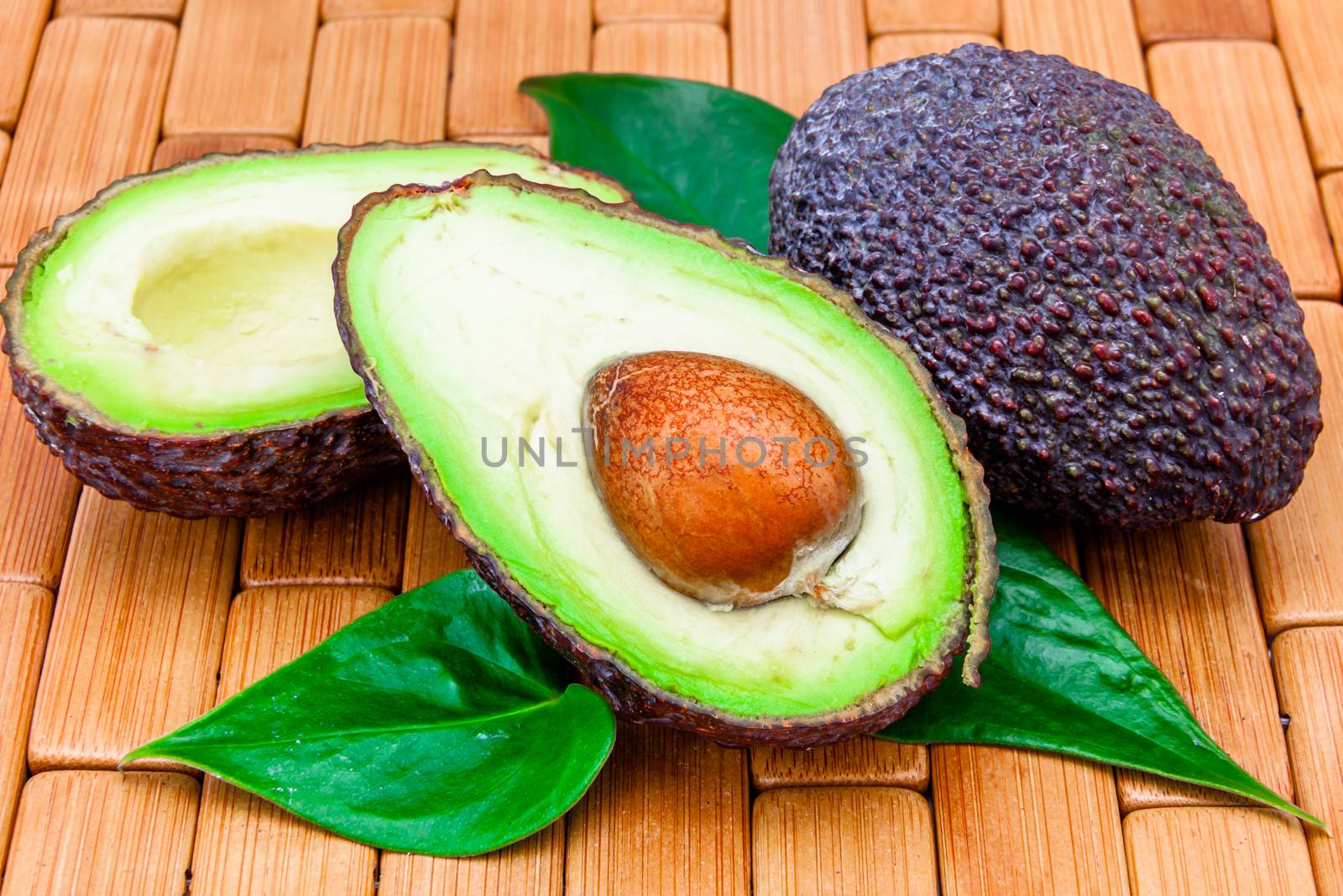 Composition of several avocados on a wood background