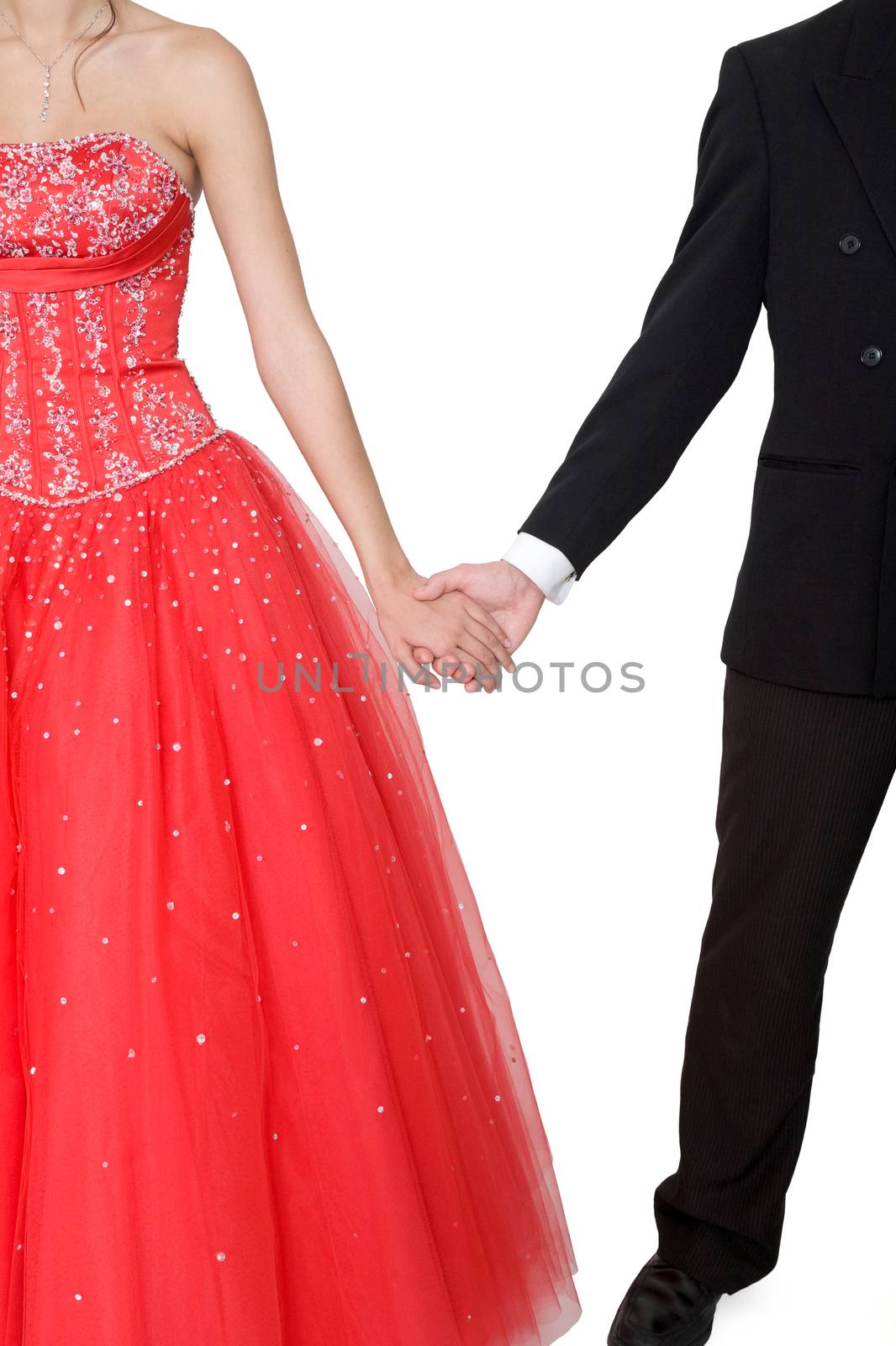 Boy & girl, in formal attire, holding hands against a white background.