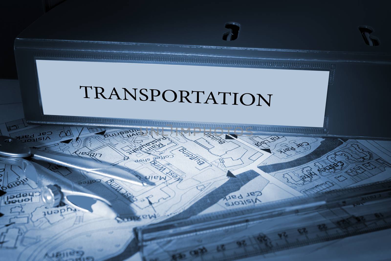 The word transportation on blue business binder on a desk