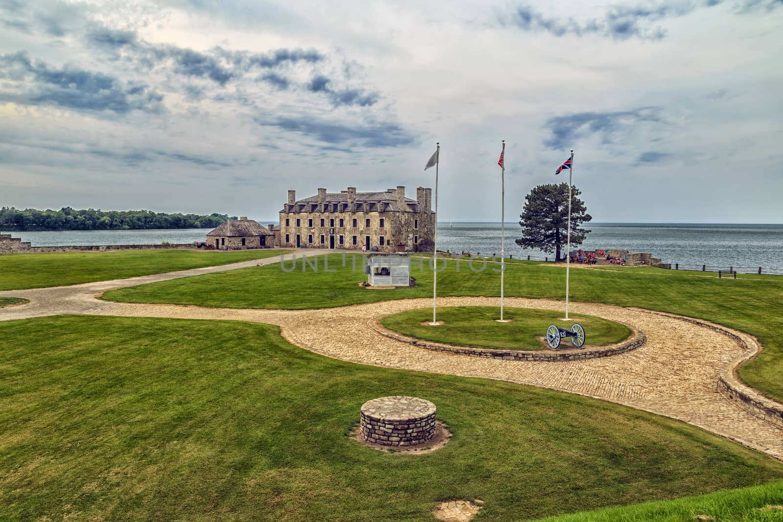 Beautiful view across the yard of the Fort Niagara. Historic french castle sits on the lake shore with bricked path leading up to it. 